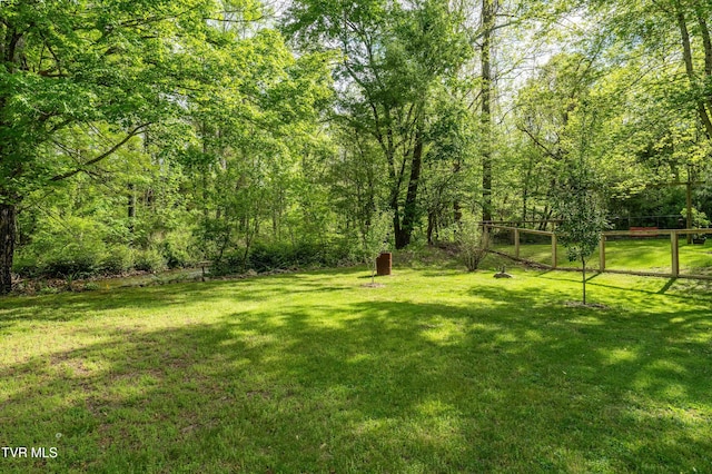 view of yard with a view of trees