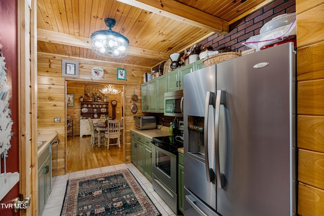 kitchen featuring green cabinetry, appliances with stainless steel finishes, light tile patterned floors, and wood ceiling