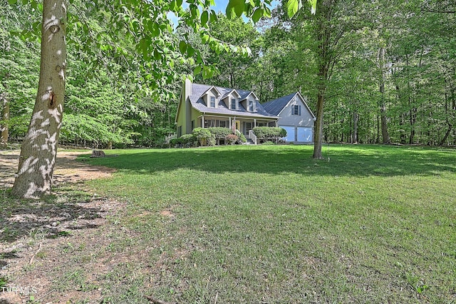 view of front of property featuring a garage, a front lawn, and a chimney