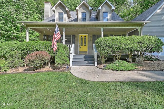 view of front of property with covered porch, a chimney, roof with shingles, and a front lawn