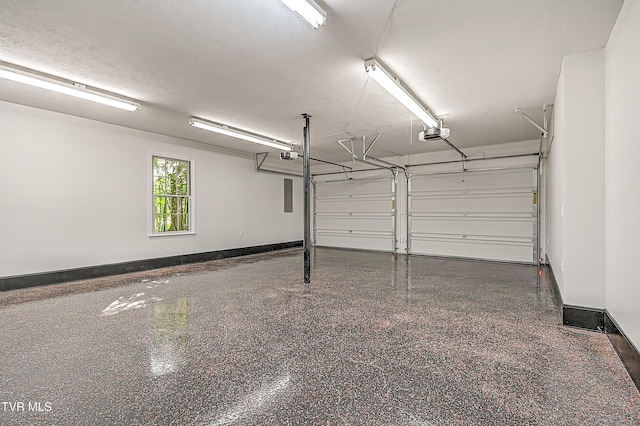 garage featuring baseboards, a garage door opener, and electric panel