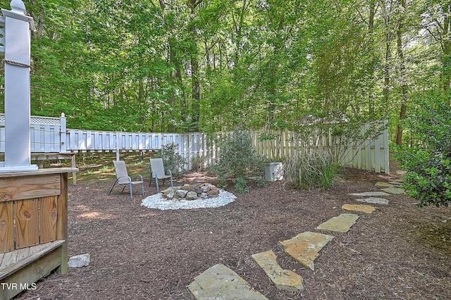 view of yard featuring fence and a fire pit