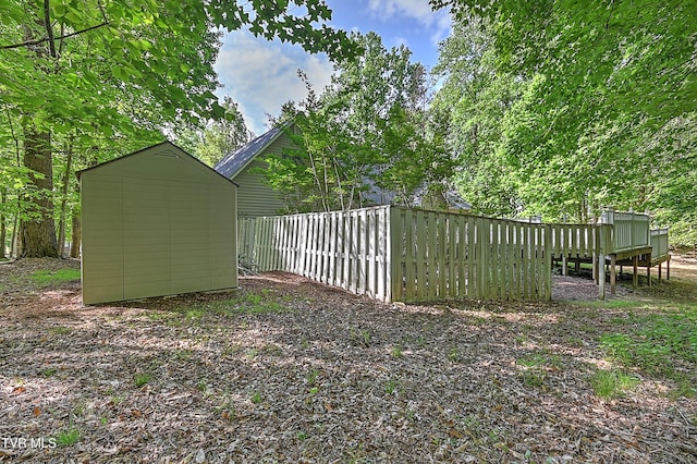 view of yard featuring a storage shed and an outdoor structure