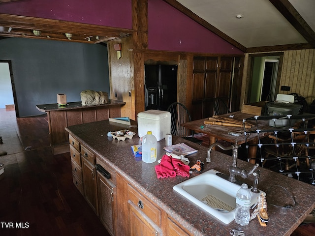 7231 Rocky Fork Rd, Wise, VA 24293 - kitchen with lofted ceiling, black fridge with ice dispenser, dark wood-style flooring, and dark stone counters