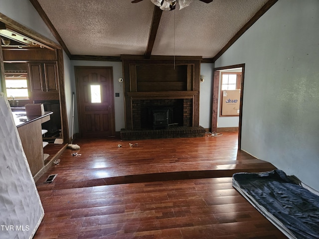 7231 Rocky Fork Rd, Wise, VA 24293 - unfurnished living room featuring vaulted ceiling, a textured ceiling, ceiling fan, wood finished floors, and a fireplace