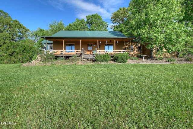 back of property featuring a lawn and a porch