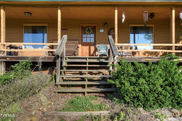 view of exterior entry with covered porch