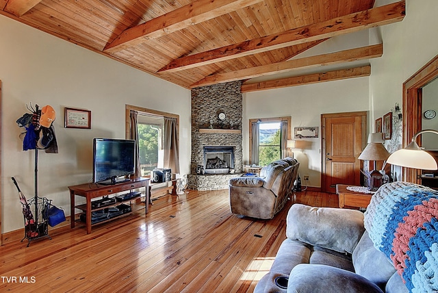 living area with wood ceiling, beamed ceiling, and a wealth of natural light
