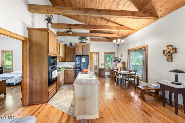 kitchen with an inviting chandelier, black appliances, wooden ceiling, and beamed ceiling