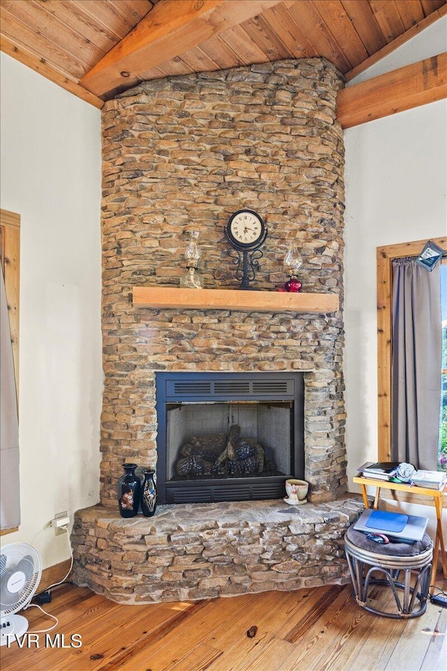 living area with wood ceiling, lofted ceiling, hardwood / wood-style floors, and a fireplace