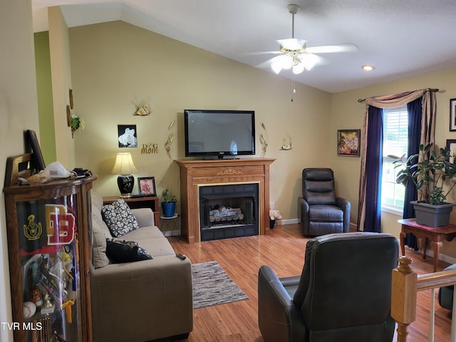living area with a fireplace, a ceiling fan, recessed lighting, wood finished floors, and lofted ceiling