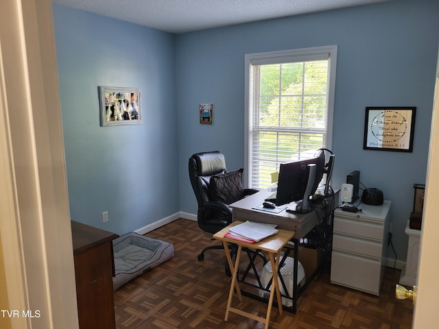 office area featuring baseboards and a healthy amount of sunlight