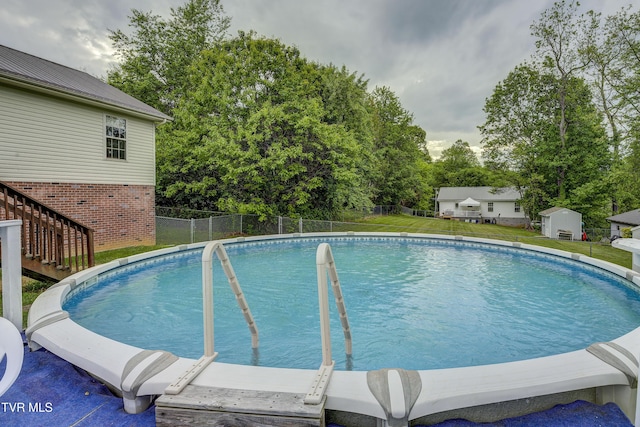 115 Maple Ridge Dr, Jonesborough, TN 37659 - view of pool with stairs, view of wooded area, and an outbuilding