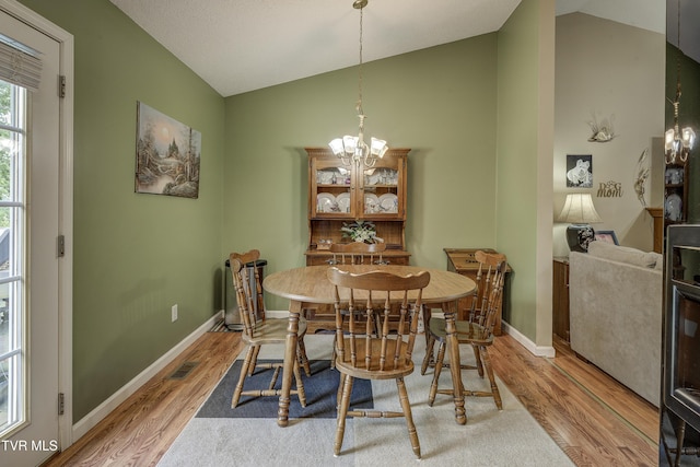 115 Maple Ridge Dr, Jonesborough, TN 37659 - dining area featuring lofted ceiling, light wood-type flooring, a chandelier, and baseboards