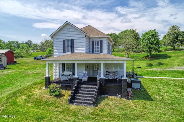 country-style home with a porch, a shingled roof, and a front lawn