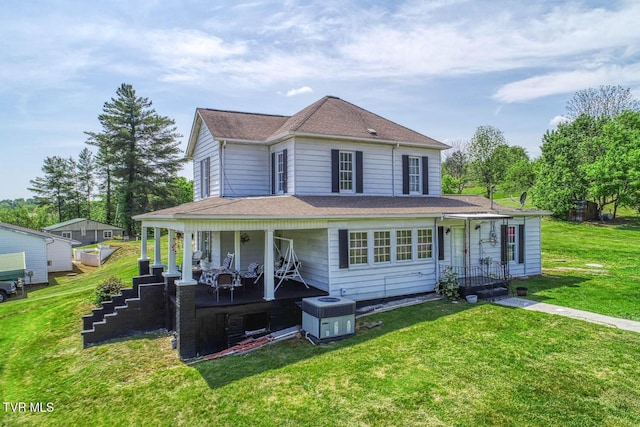 farmhouse featuring roof with shingles, a porch, and a front lawn