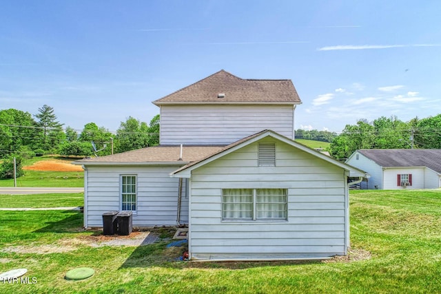 back of house with a lawn