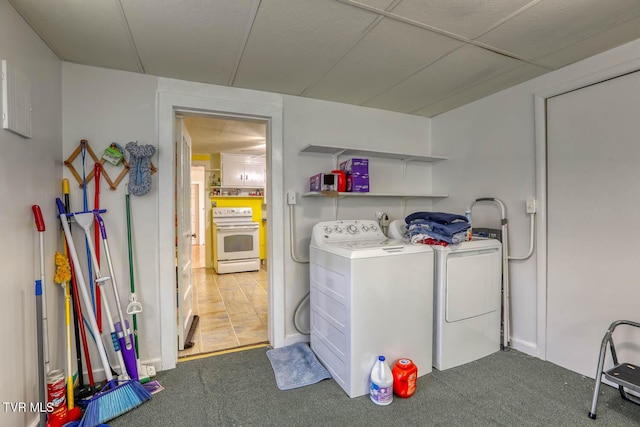 clothes washing area featuring laundry area, carpet, and washer and dryer