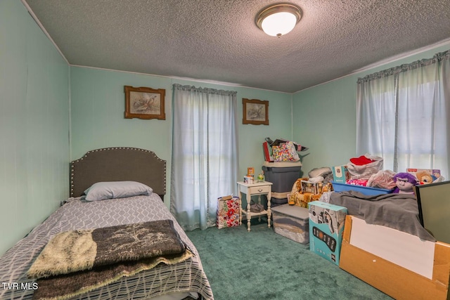 bedroom featuring carpet floors, ornamental molding, and a textured ceiling