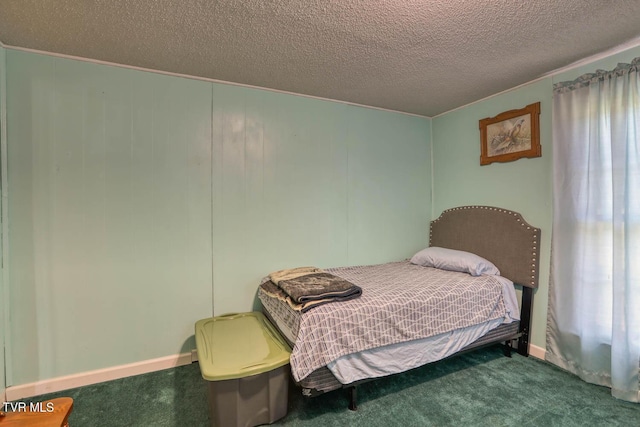 carpeted bedroom featuring a textured ceiling and multiple windows
