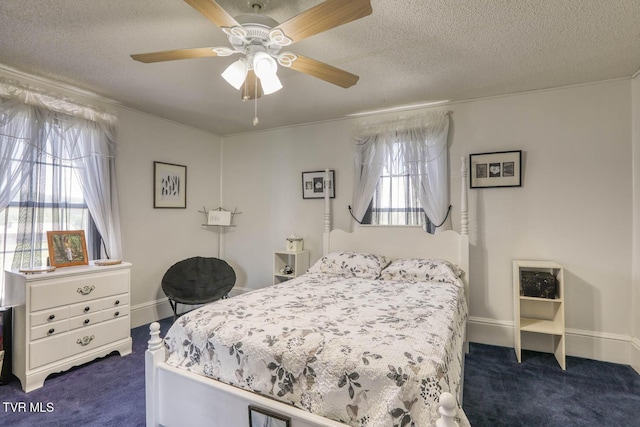 bedroom with a ceiling fan, dark colored carpet, and a textured ceiling