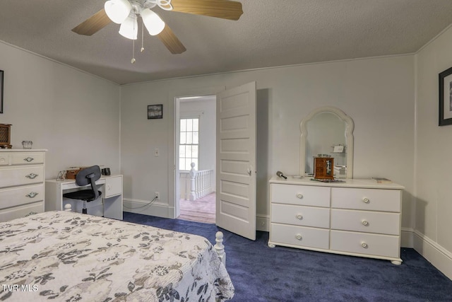 bedroom with dark carpet, a textured ceiling, ceiling fan, and baseboards