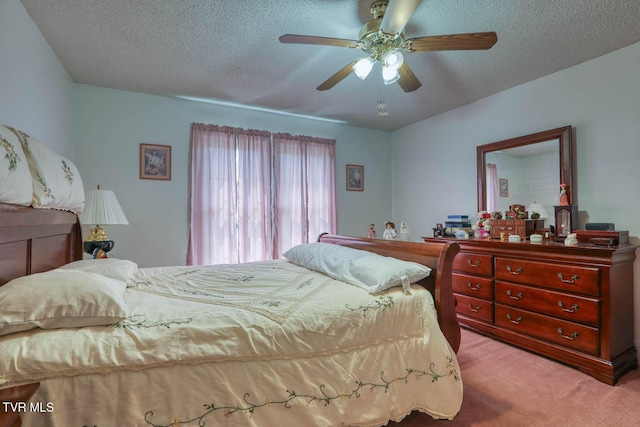 bedroom featuring carpet flooring, a ceiling fan, and a textured ceiling