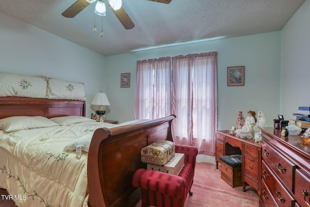 bedroom featuring light colored carpet, a textured ceiling, and ceiling fan