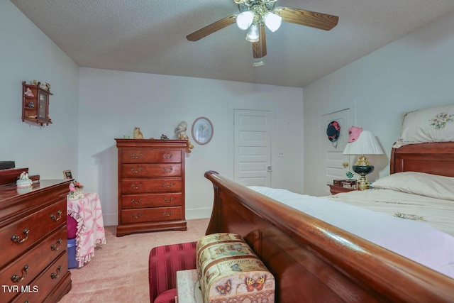 bedroom featuring ceiling fan, a textured ceiling, and light colored carpet