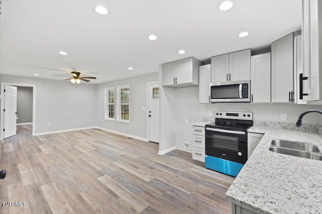 115 Rb Miller Rd, Limestone, TN 37681 - kitchen featuring baseboards, ceiling fan, light stone counters, a sink, and appliances with stainless steel finishes
