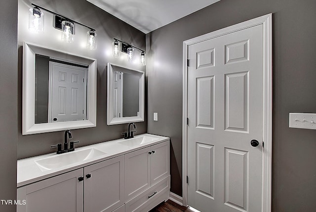 115 Rb Miller Rd, Limestone, TN 37681 - bathroom featuring a sink, baseboards, double vanity, and wood finished floors