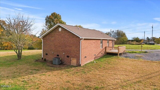 115 Rb Miller Rd, Limestone, TN 37681 - view of side of home featuring a deck, brick siding, crawl space, a lawn, and central air condition unit