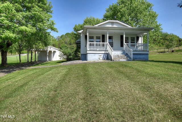 view of front of property featuring covered porch, a front yard, and a carport