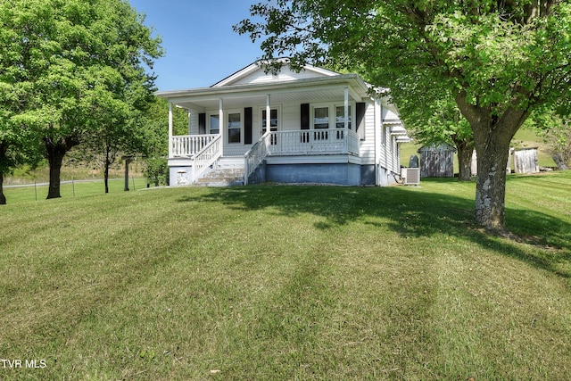 view of front of property with central air condition unit, covered porch, and a front lawn