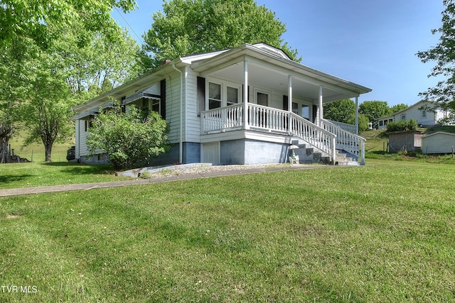 view of front of house featuring covered porch, stairs, and a front lawn