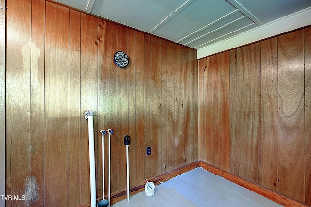 interior space featuring wood finished floors and wooden walls