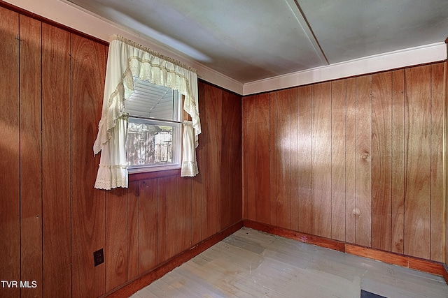 unfurnished room featuring wood walls and light wood-type flooring