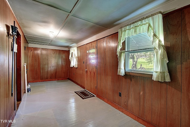 interior space featuring light wood finished floors and wood walls