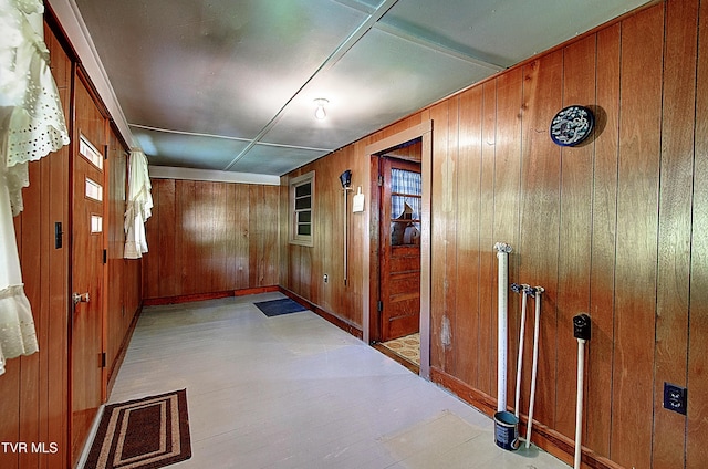 interior space with baseboards and wooden walls