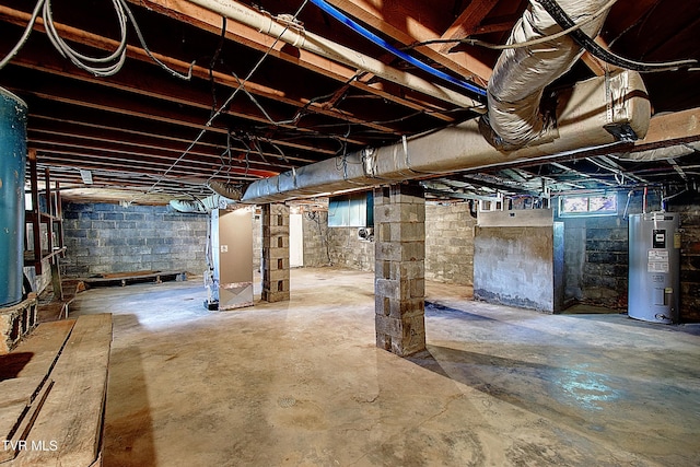 below grade area featuring heating unit and electric water heater