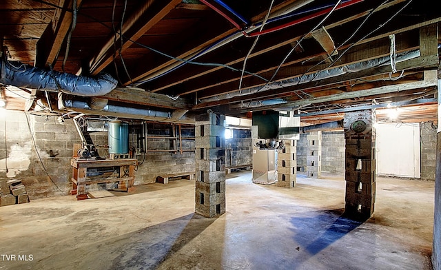 unfinished below grade area with heating unit and gas water heater
