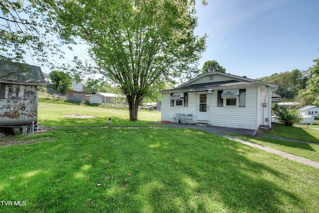 back of property featuring a yard