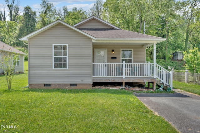228 Taylor St, Bristol, TN 37620 - view of front of house with covered porch, crawl space, a front yard, fence, and a shingled roof
