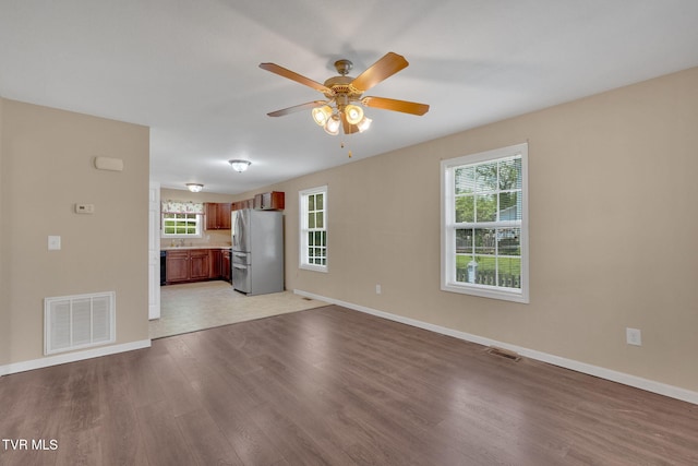 228 Taylor St, Bristol, TN 37620 - unfurnished living room featuring visible vents, a ceiling fan, light wood finished floors, and baseboards