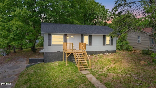 bungalow-style home with crawl space and roof with shingles