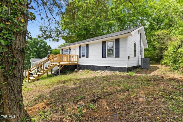 manufactured / mobile home with crawl space, a deck, central AC, a shingled roof, and stairs