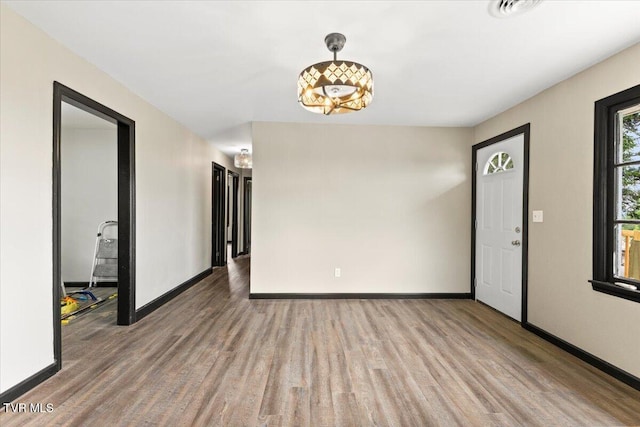 interior space with baseboards and wood finished floors