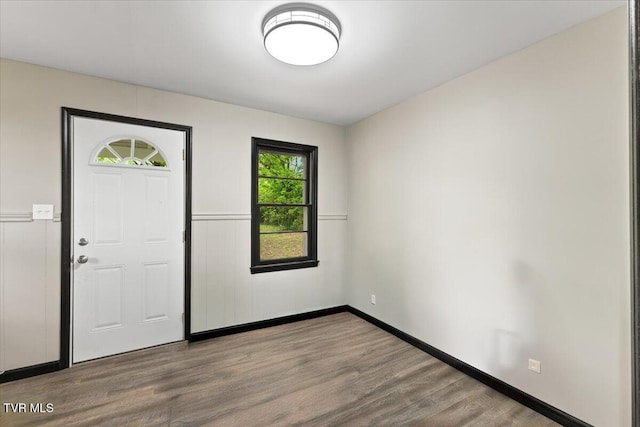 foyer with baseboards and wood finished floors