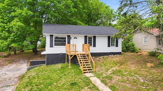 bungalow featuring a shingled roof and crawl space
