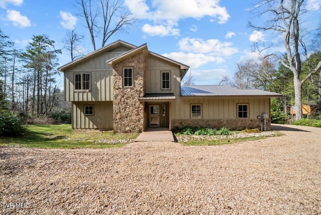 342 Ripshin Lake Rd, Roan Mountain, TN 37687 - view of front of house featuring board and batten siding, metal roof, and stone siding